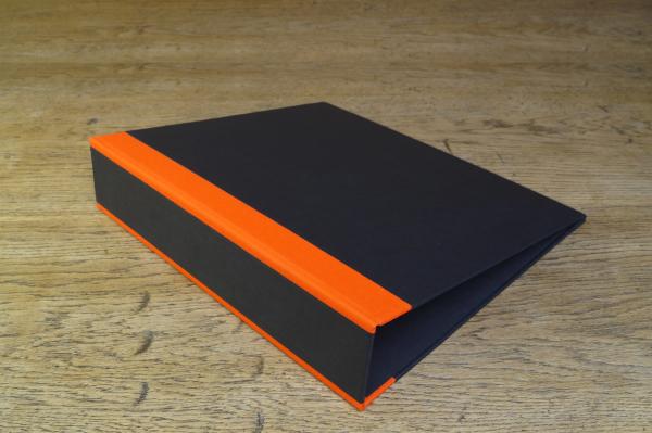 black folder with orange linen edges